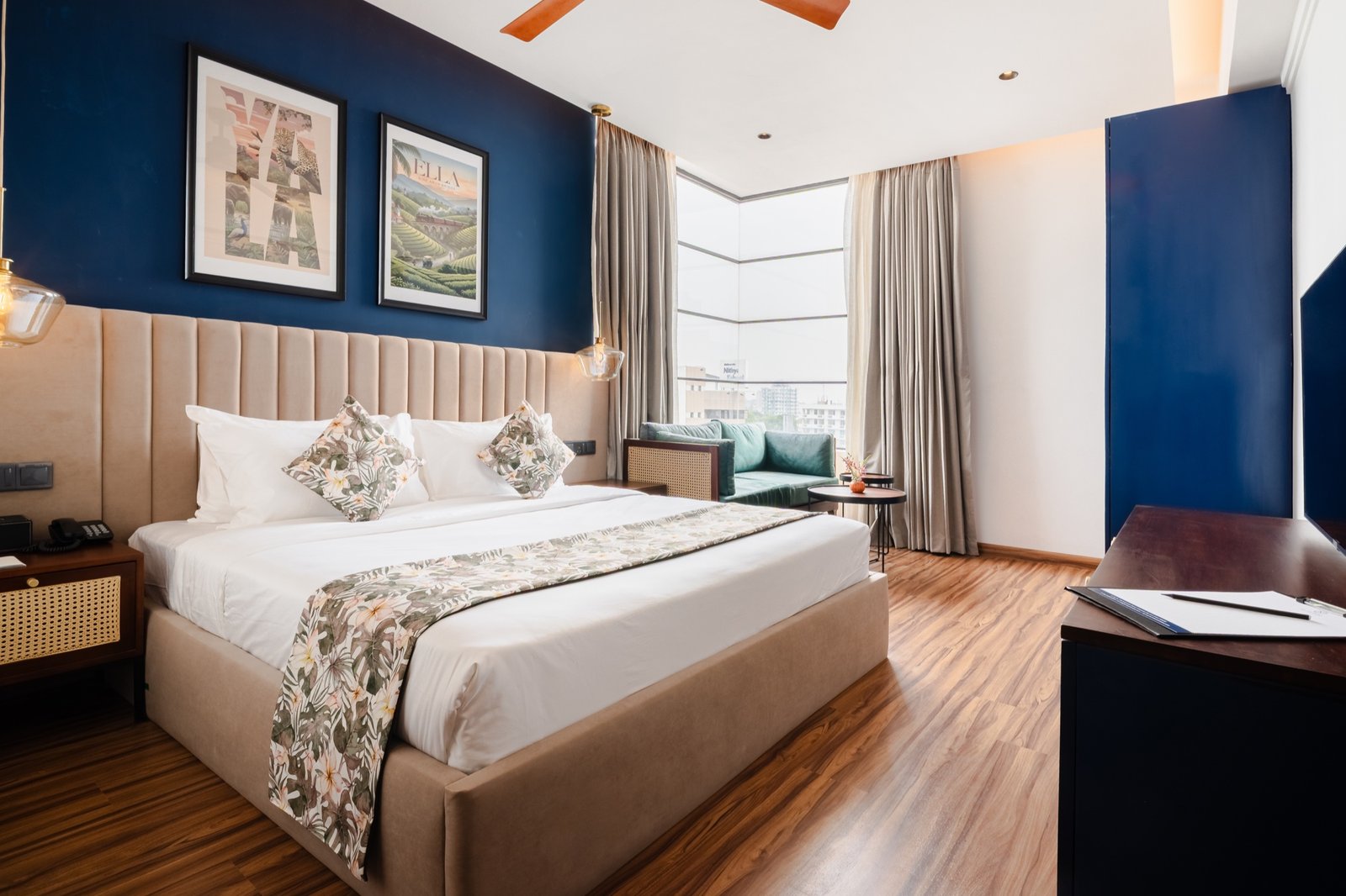 Superior King Room with blue feature wall and city-view seating